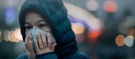 A child wearing a face mask for protection against smog. (Photo: Shutterstock)